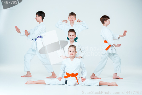 Image of The group of boys and girl fighting at Aikido training in martial arts school. Healthy lifestyle and sports concept