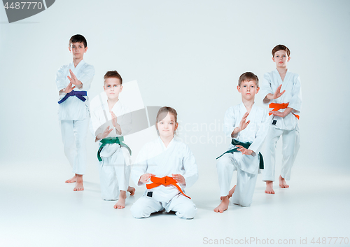 Image of The group of boys and girl fighting at Aikido training in martial arts school. Healthy lifestyle and sports concept