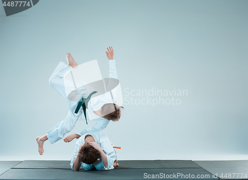 Image of The two boys fighting at Aikido training in martial arts school. Healthy lifestyle and sports concept