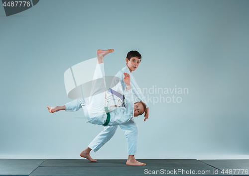 Image of The two boys fighting at Aikido training in martial arts school. Healthy lifestyle and sports concept