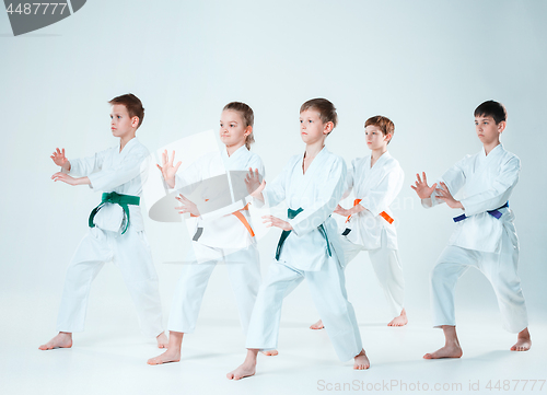 Image of The group of boys and girl fighting at Aikido training in martial arts school. Healthy lifestyle and sports concept