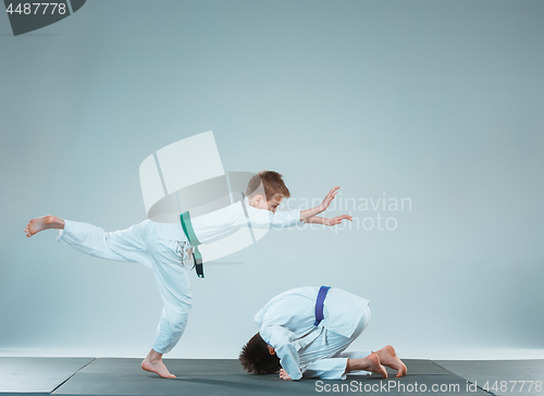 Image of The two boys fighting at Aikido training in martial arts school. Healthy lifestyle and sports concept