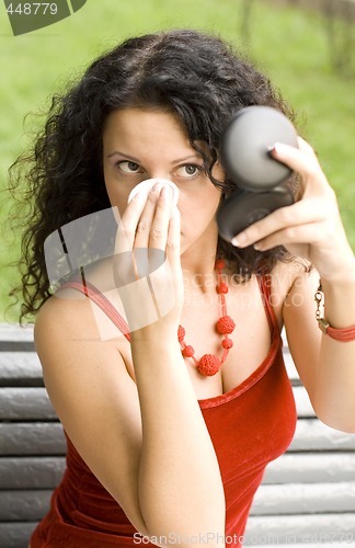 Image of woman applying foundation