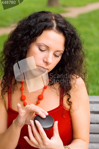 Image of beautiful woman with mirror