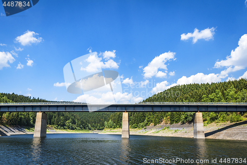 Image of Large bridge over a lake near a forest