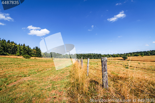 Image of Rural scenery with a fence on dry land in the summer