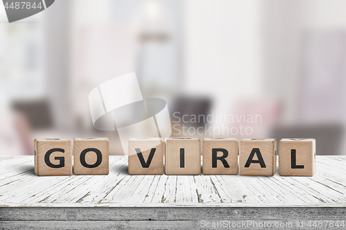 Image of Go viral message sign on a wooden table