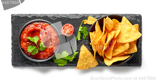 Image of corn chips nachos and salsa sauce