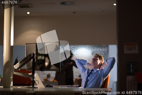 Image of businessman relaxing at the desk