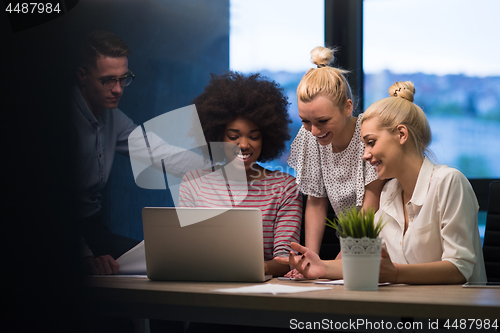 Image of Multiethnic startup business team in night office