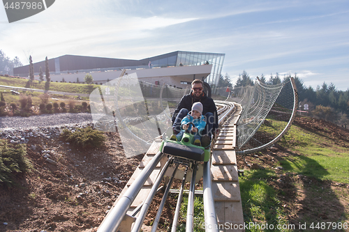 Image of father and son enjoys driving on alpine coaster