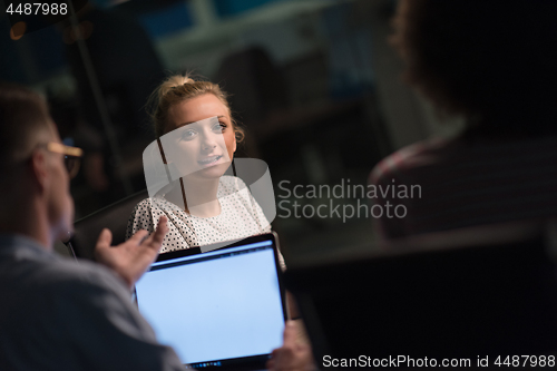 Image of Multiethnic startup business team in night office