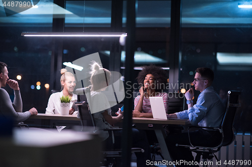 Image of Multiethnic startup business team in night office