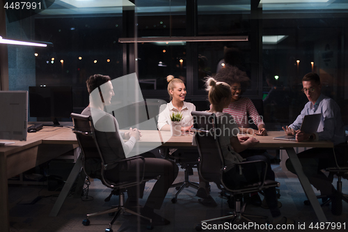 Image of Multiethnic startup business team in night office