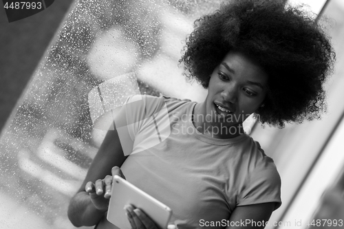 Image of african american woman using tablet