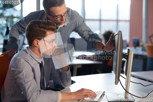 Image of Two Business People Working With computer in office