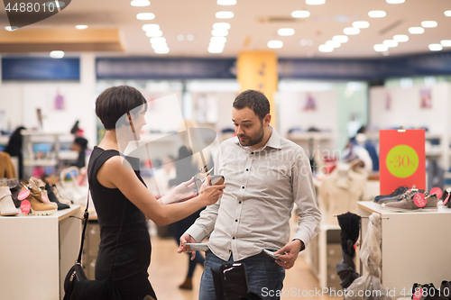 Image of couple chooses shoes At Shoe Store