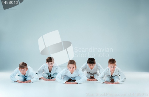 Image of The group of boys and girl fighting at Aikido training in martial arts school. Healthy lifestyle and sports concept