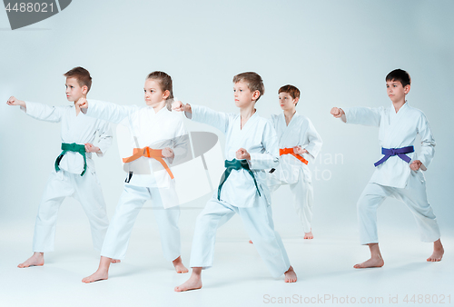 Image of The group of boys and girl fighting at Aikido training in martial arts school. Healthy lifestyle and sports concept