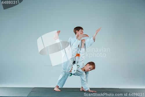 Image of The two boys fighting at Aikido training in martial arts school. Healthy lifestyle and sports concept