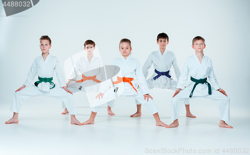 Image of The group of boys and girl fighting at Aikido training in martial arts school. Healthy lifestyle and sports concept