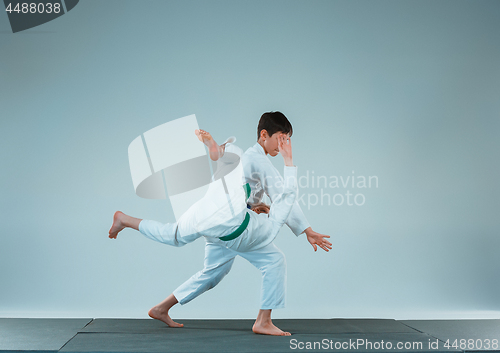 Image of The two boys fighting at Aikido training in martial arts school. Healthy lifestyle and sports concept