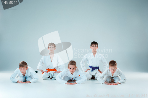 Image of The group of boys and girl fighting at Aikido training in martial arts school. Healthy lifestyle and sports concept