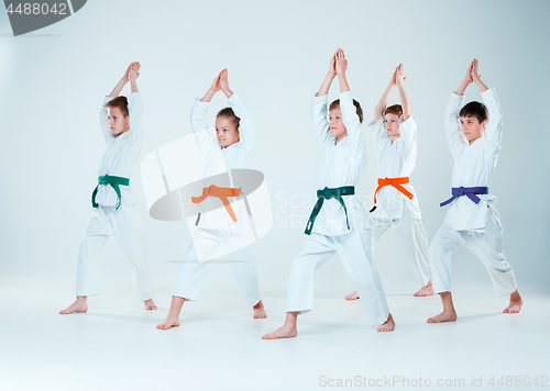Image of The group of boys and girl fighting at Aikido training in martial arts school. Healthy lifestyle and sports concept