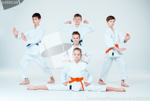 Image of The group of boys and girl fighting at Aikido training in martial arts school. Healthy lifestyle and sports concept