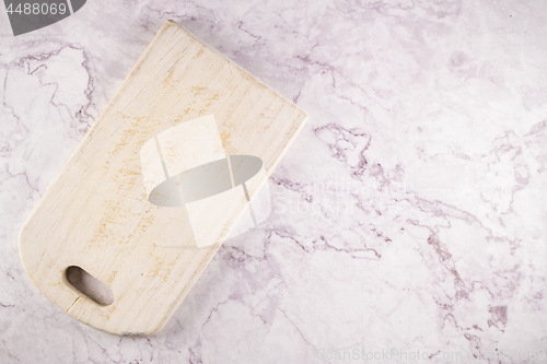 Image of Wooden cutting board on a gray marble background