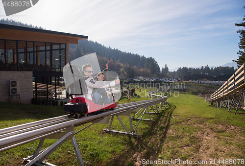 Image of couple enjoys driving on alpine coaster