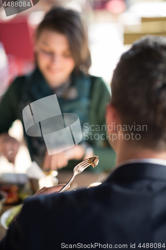 Image of Closeup shot of young woman and man having meal.