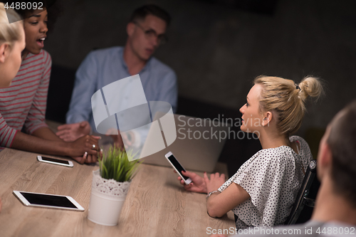 Image of Multiethnic startup business team in night office
