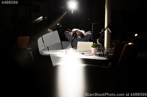 Image of businessman relaxing at the desk