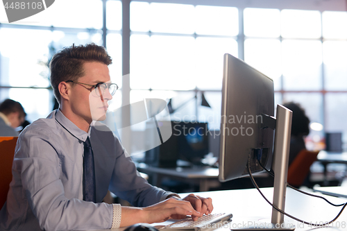 Image of businessman working using a computer in startup office