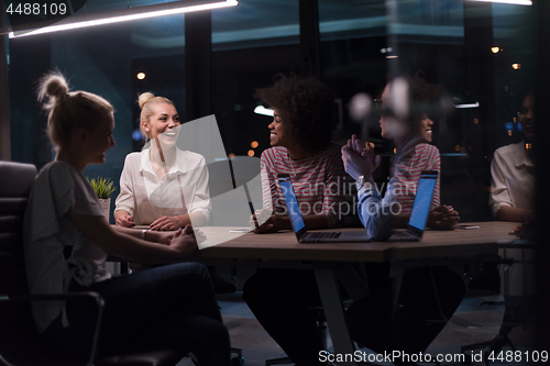 Image of Multiethnic startup business team in night office