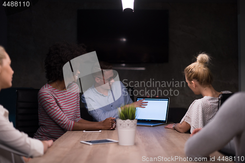 Image of Multiethnic startup business team in night office