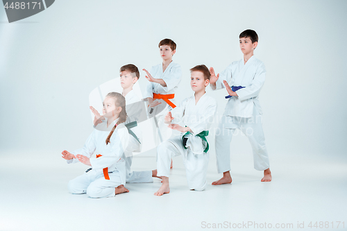 Image of The group of boys and girl fighting at Aikido training in martial arts school. Healthy lifestyle and sports concept