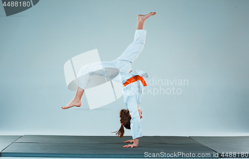 Image of The girl posing at Aikido training in martial arts school. Healthy lifestyle and sports concept