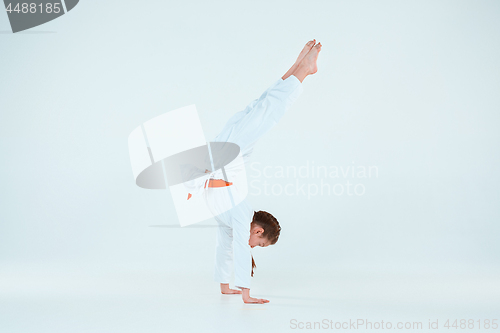 Image of The girl posing at Aikido training in martial arts school. Healthy lifestyle and sports concept