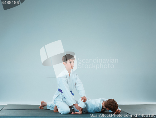 Image of The two boys fighting at Aikido training in martial arts school. Healthy lifestyle and sports concept