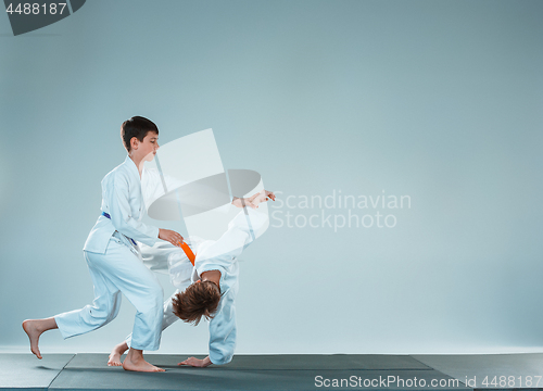 Image of The two boys fighting at Aikido training in martial arts school. Healthy lifestyle and sports concept