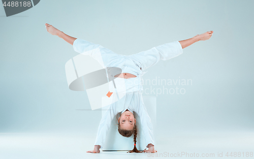 Image of The girl posing at Aikido training in martial arts school. Healthy lifestyle and sports concept