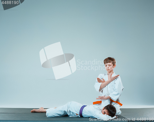 Image of The two boys fighting at Aikido training in martial arts school. Healthy lifestyle and sports concept