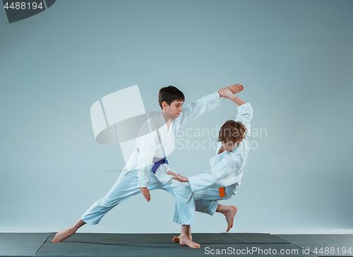 Image of The two boys fighting at Aikido training in martial arts school. Healthy lifestyle and sports concept