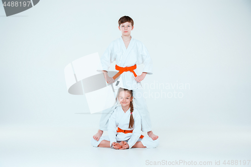 Image of The group of boys and girl at Aikido training in martial arts school. Healthy lifestyle and sports concept