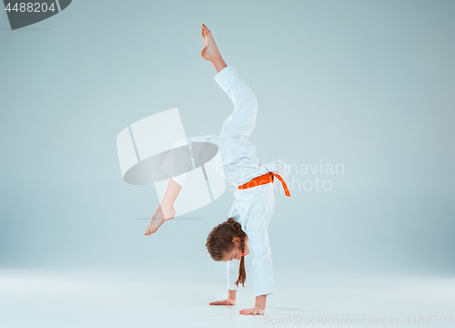 Image of The girl posing at Aikido training in martial arts school. Healthy lifestyle and sports concept