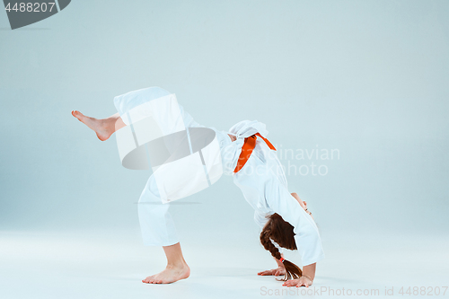 Image of The girl posing at Aikido training in martial arts school. Healthy lifestyle and sports concept