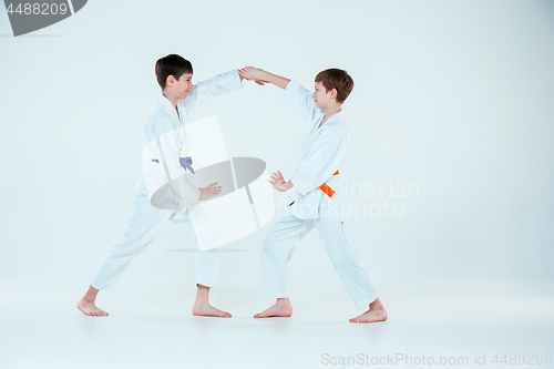 Image of The two boys fighting at Aikido training in martial arts school. Healthy lifestyle and sports concept