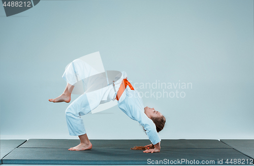 Image of The girl posing at Aikido training in martial arts school. Healthy lifestyle and sports concept